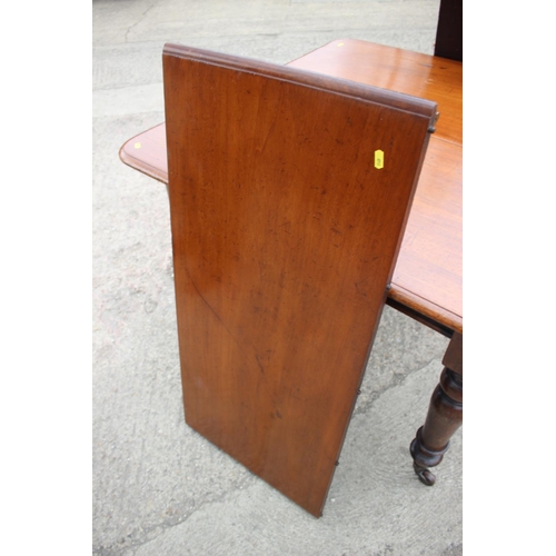 470 - A late 19th century mahogany extending dining table with two extra leaves, on turned supports, 74