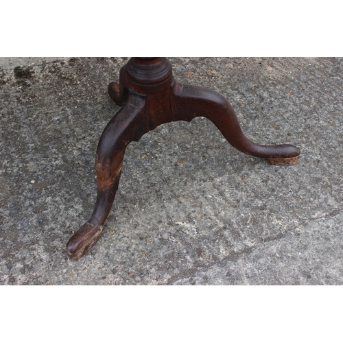 475 - A Georgian mahogany circular tilt top occasional table, on turned column and tripod splayed supports... 