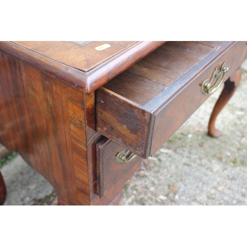 476 - A Georgian walnut and leather topped lowboy, fitted one long drawer over three short drawers and sha... 