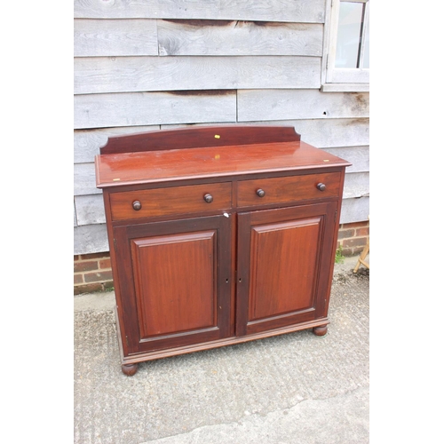 477 - A 19th century ledge back sideboard, fitted two drawers over cupboard enclosed two panel doors, on b... 