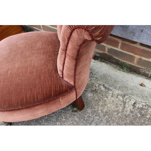 488 - A late 19th century low seat nursing chair, button upholstered in Dralon, on castored supports