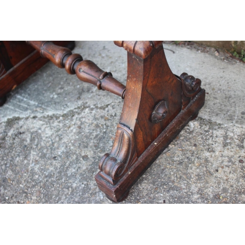 502 - A Victorian carved rosewood firescreen with floral needlepoint panel, on splay supports, 18