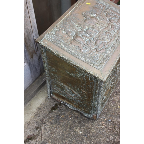 529 - An embossed brass log box with figure decoration, 22 1/2