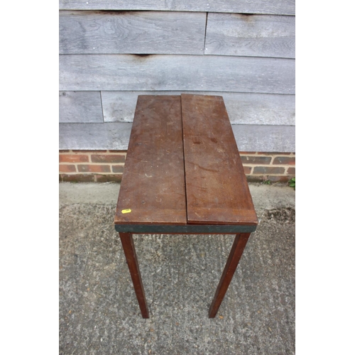 531 - An early 20th century mahogany and brass mounted folding table with opening top, on square supports,... 