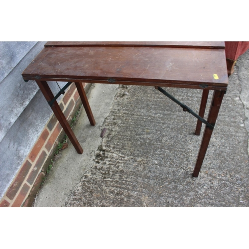 531 - An early 20th century mahogany and brass mounted folding table with opening top, on square supports,... 