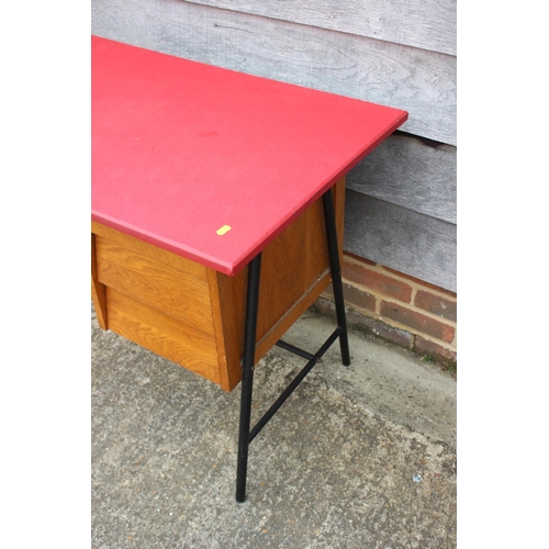 537 - A 1970s desk with leatherette top, fitted three drawers, on metal supports, 39