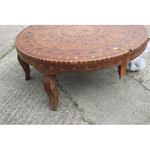 540 - A 1930s geometric inlaid walnut low circular coffee table, on cabriole supports, 33 1/2