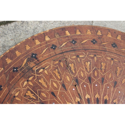 540 - A 1930s geometric inlaid walnut low circular coffee table, on cabriole supports, 33 1/2