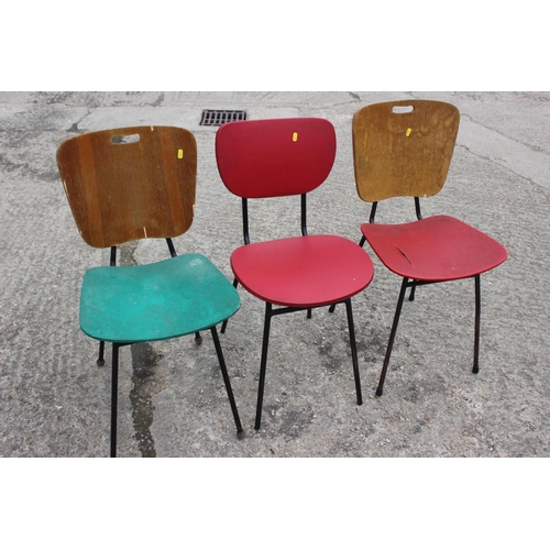 541 - Three 1960s painted padded shaped back and seat dining chairs, on metal supports