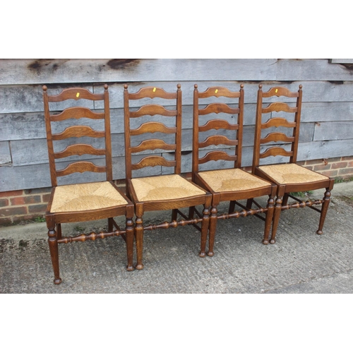 543 - A set of four ladder back dining chairs with rush envelope seats, on turned and stretchered supports