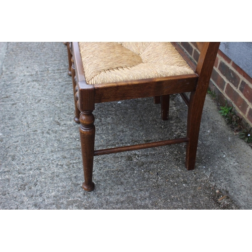 543 - A set of four ladder back dining chairs with rush envelope seats, on turned and stretchered supports