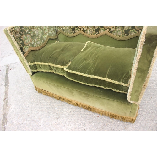 550 - A Knole settee, upholstered in a green velvet with brocaded panels, 66