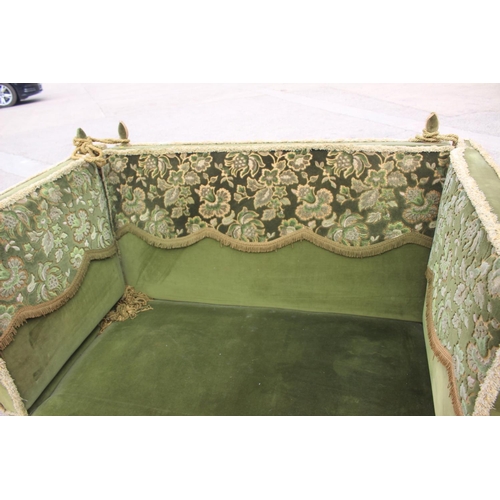 551 - A Knole settee, upholstered in a green velvet with brocaded panels, 66