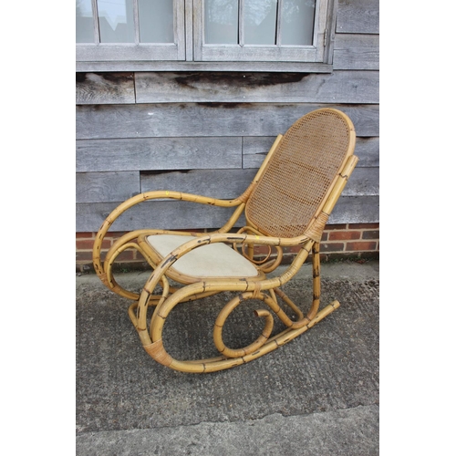 555 - A rattan rocking chair and a rattan low coffee table