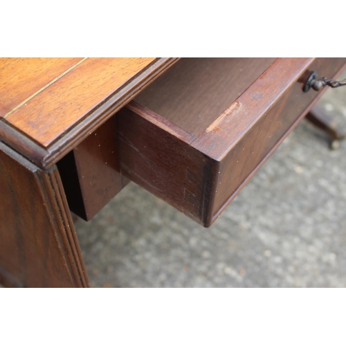 560 - A mahogany and brass line inlaid sofa table, fitted two drawers, on lyre end supports, 57