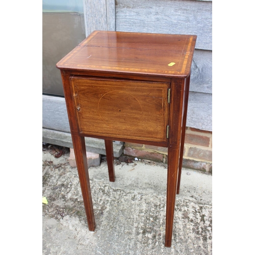 573 - An Edwardian walnut and line inlaid bedside cupboard enclosed one door, on square taper supports, 14... 