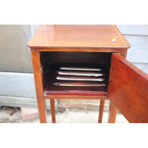 573 - An Edwardian walnut and line inlaid bedside cupboard enclosed one door, on square taper supports, 14... 