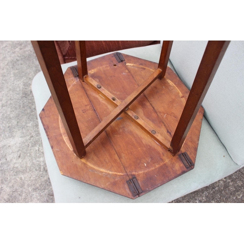 576 - A walnut folding octagonal top occasional table, on splay supports, 18