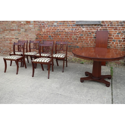 587 - A reproduction polished as mahogany circular  extending dining table with one extra leaf, on faceted... 