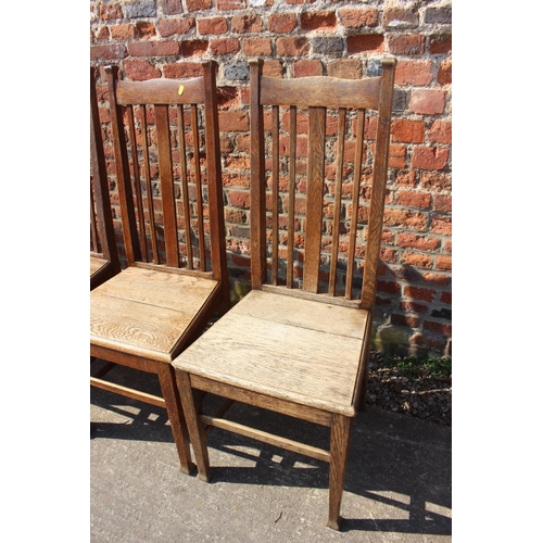 589 - A set of six early 20th century oak vertical rail back dining chairs with panel seats