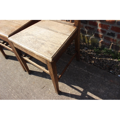 589 - A set of six early 20th century oak vertical rail back dining chairs with panel seats