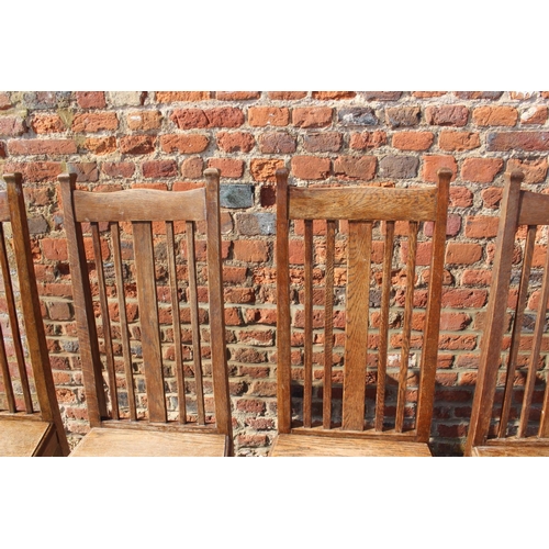 589 - A set of six early 20th century oak vertical rail back dining chairs with panel seats