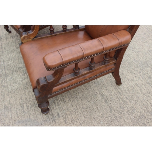 590 - A pair of Edwardian walnut and leatherette open armchairs, on turned supports