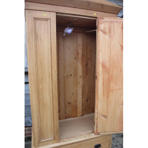 594 - A waxed pine wardrobe enclosed mirror door over one drawer, on block base, 42