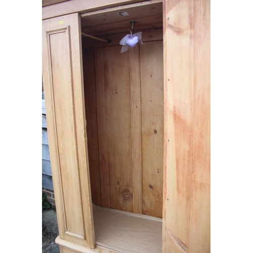 594 - A waxed pine wardrobe enclosed mirror door over one drawer, on block base, 42