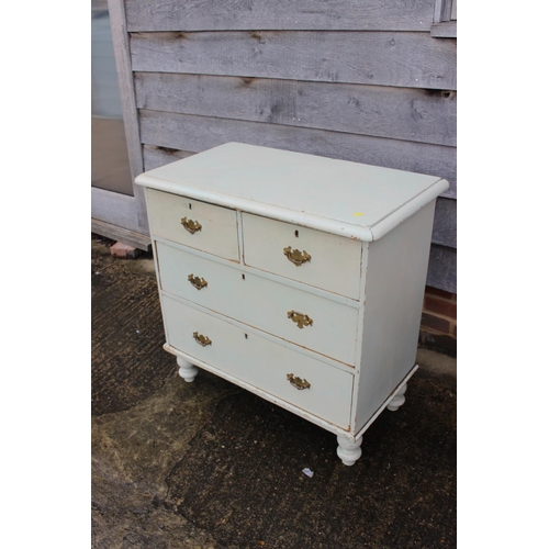 600 - A Victorian cream painted pine chest of two short and two long drawers, on turned supports, 33