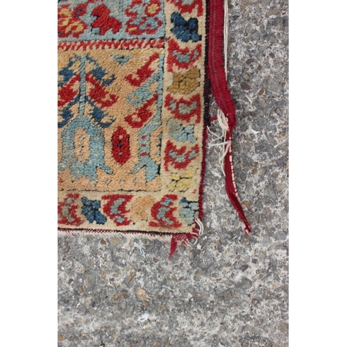 609 - A Middle Eastern wool prayer rug with medallion, geometric and floral designs in shades of blue and ... 