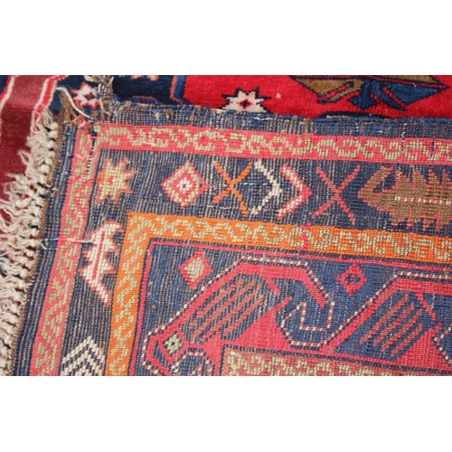 610 - A Middle Eastern wool rug with central medallion, geometric design and multi-bordered in shades of o... 