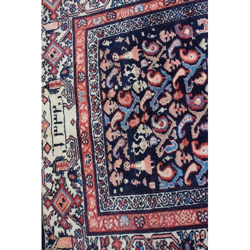 611 - An Iranian silk and wool rug with fourteen elephant guls, geometric designs and multi-bordered in sh... 