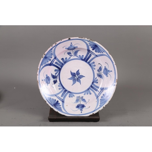 71 - An 18th century Delft blue and white bowl with floral decoration, 12 1/4