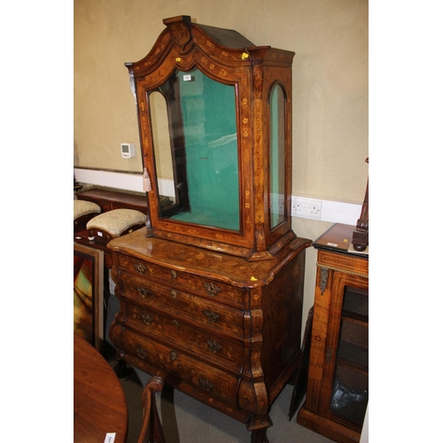 437 - A late 19th century Dutch figured walnut marquetry bombe display cabinet, the upper section enclosed... 