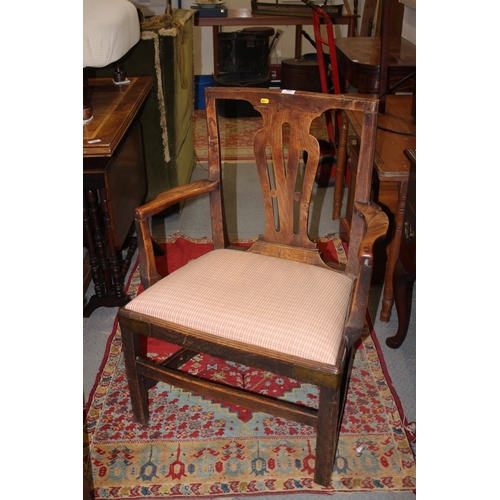 440 - A late 18th century oak and chestnut elbow chair with panel seat and pierced splat back, on chamfere... 