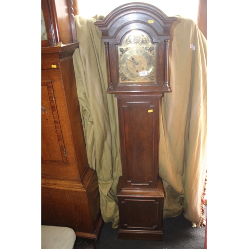 516 - An oak long case clock with arch top brass dial and striking and chiming movement, 63