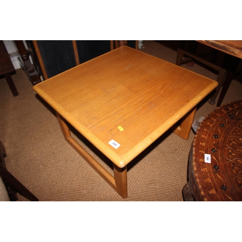 534 - A 1970s light oak shape top two-tier coffee table with inset glass top, on shaped supports, 42