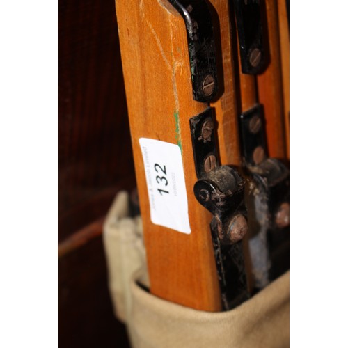 132 - A WWII camp bed, in canvas bag