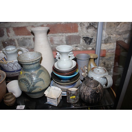 103 - A quantity of studio pottery, including a frog, three teapots, plates, bowls, jugs and other items