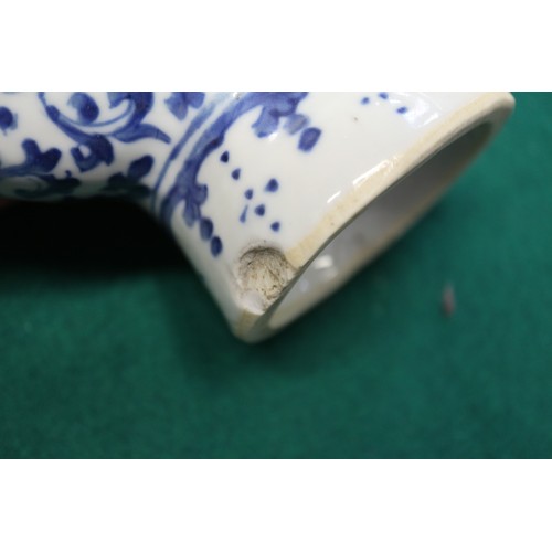 105 - A Chinese blue and white moon flask with relief lizard, leaf and scrolled decoration, 9 1/2