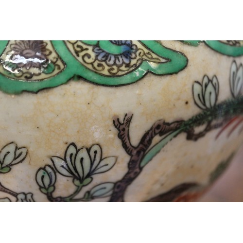 108 - A pair of Chinese famille verte crackle glazed baluster jars and covers with birds in a landscape de... 