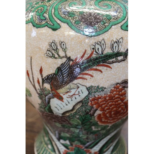 108 - A pair of Chinese famille verte crackle glazed baluster jars and covers with birds in a landscape de... 