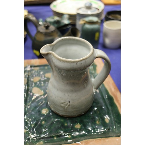 103 - A quantity of studio pottery, including a frog, three teapots, plates, bowls, jugs and other items