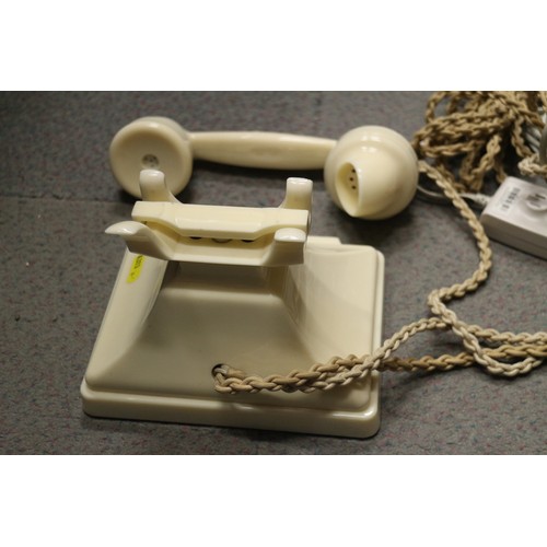 125 - A 200 series cream Bakelite telephone with wall 