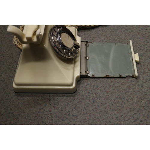 125 - A 200 series cream Bakelite telephone with wall 