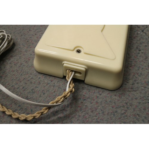 125 - A 200 series cream Bakelite telephone with wall 