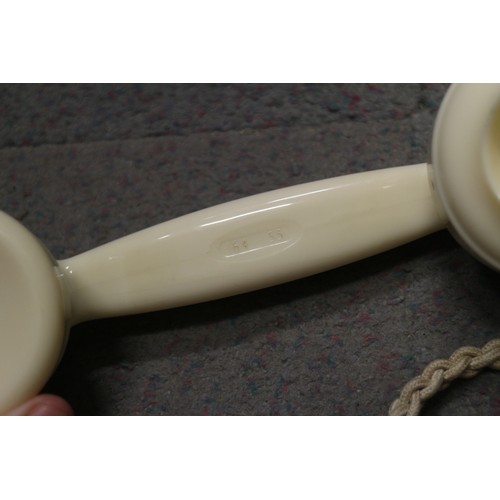 125 - A 200 series cream Bakelite telephone with wall 