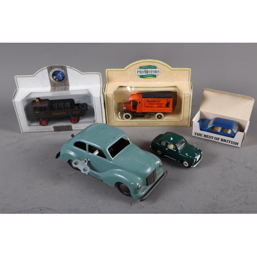 216 - A Japanese tin-plate wind-up model car, a Corgi die-cast model Austin Mini Metro, two Lledo 