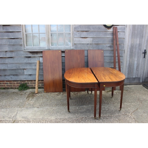 540 - A late 19th century mahogany dining table with three extra leaves, on square taper supports and bras... 